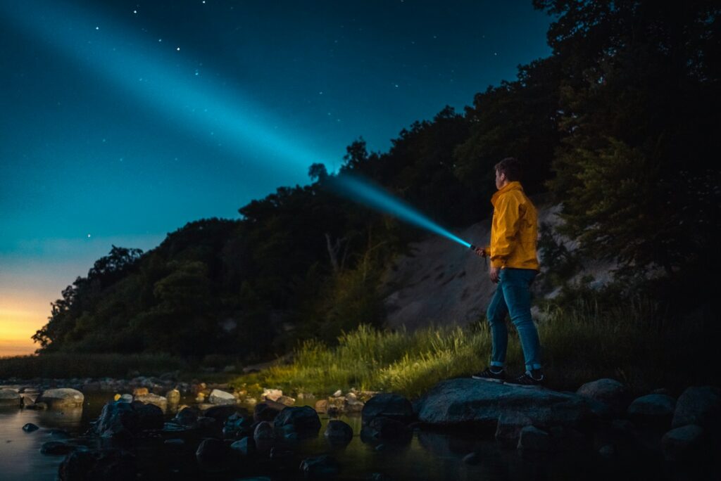 Top 5 Devices that Work Best with USB-C Rechargeable Batteries 5 man holding flashlight standing on gray stone during nighttime
